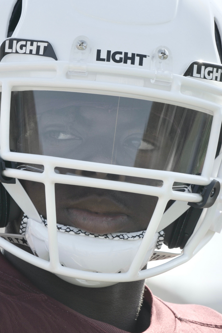 Football player wearing a white LIGHT LS2 football helmet