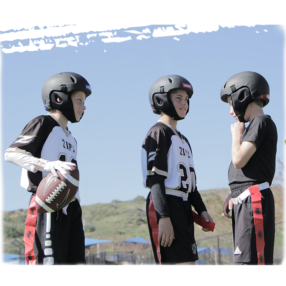 Three youth flag football players all wearing LIGHT SS1 helmets