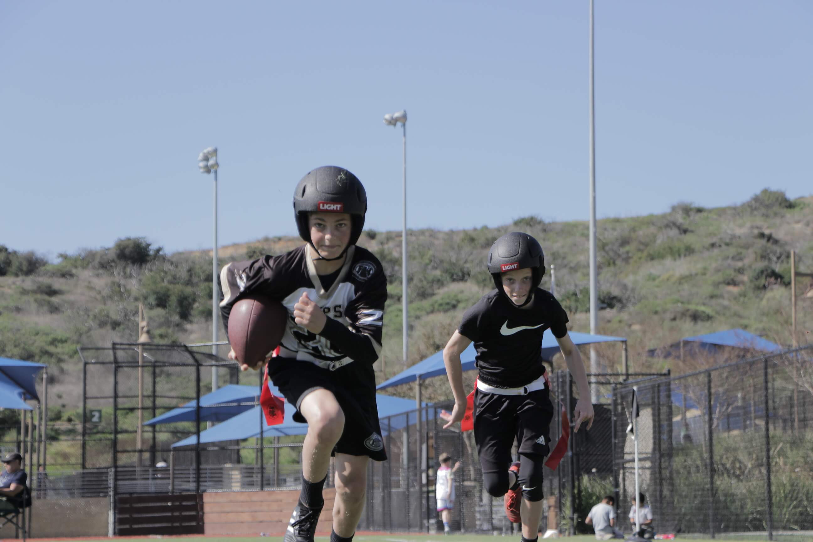 Kids Running playing flag football wearing SS1 Helmets