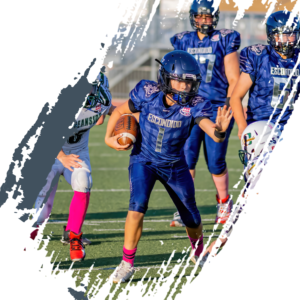 Young football player wearing a Navy blue LIGHT Helmet while making a play on the football field