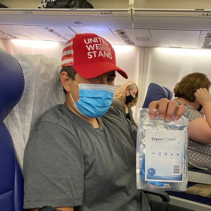 Boy on plane wearing ppe