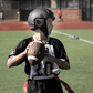 Kid wearing ss1 helmet throwing football