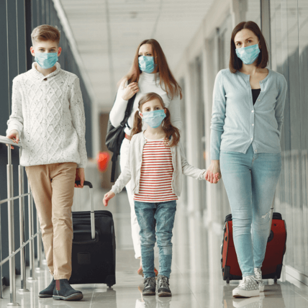 People in airport wearing ppe